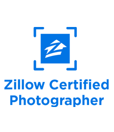 A blue and white logo for zillow certified photographer.