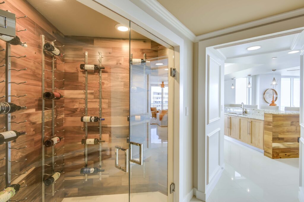 A bathroom with a glass shower door and wooden walls.