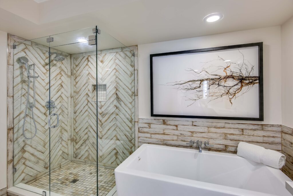 A bathroom with a large tub and walk in shower.