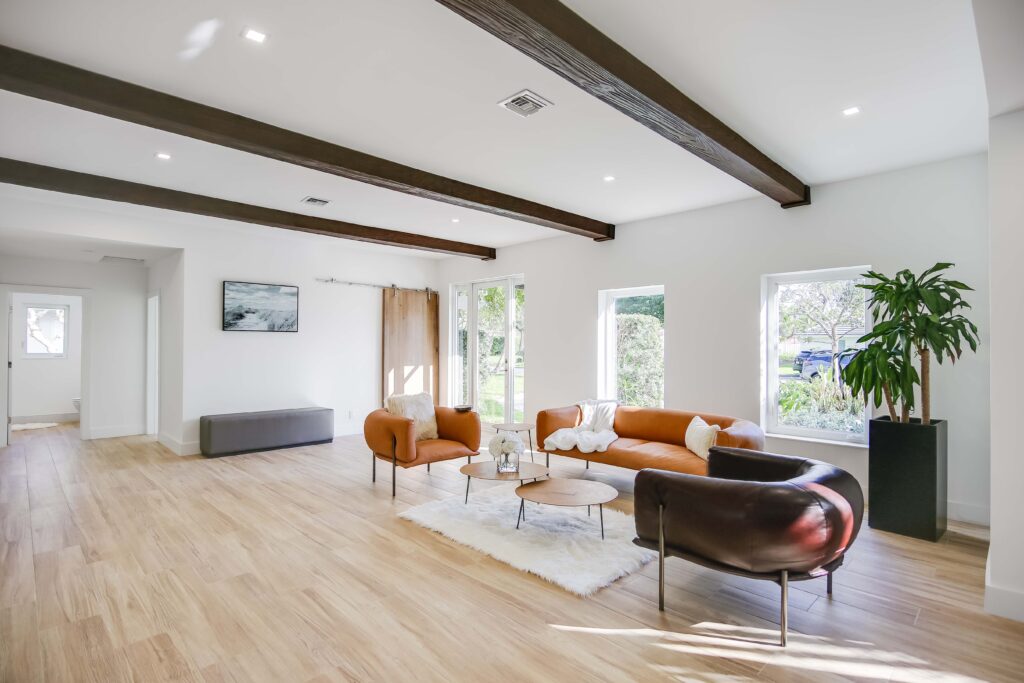 A living room with wooden floors and white walls.