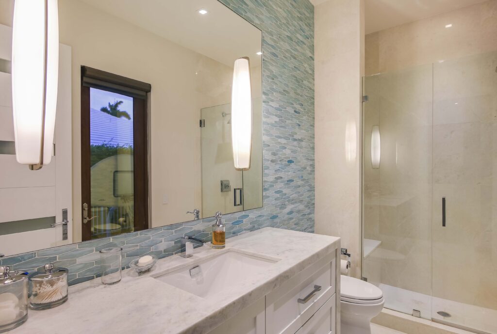 A bathroom with two sinks and a large mirror.